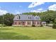 Charming home featuring red shutters, a well-manicured lawn, and beautiful curb appeal at 3573 Northern Estates Cir, Rocky Mount, NC 27804