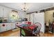 Cozy kitchen with white cabinets, hardwood floors, and a chandelier above a wooden dining table at 3573 Northern Estates Cir, Rocky Mount, NC 27804