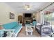 Cozy living room featuring a brick fireplace, ceiling fan, and sliding glass doors to the outdoor deck at 3573 Northern Estates Cir, Rocky Mount, NC 27804