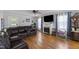 Cozy living room features hardwood floors, a fireplace, and comfortable leather seating at 3573 Northern Estates Cir, Rocky Mount, NC 27804