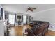 Bright living room with hardwood floors, a leather sofa, and large windows at 3573 Northern Estates Cir, Rocky Mount, NC 27804