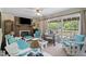 Bright living room with brick fireplace, ceiling fan, and sliding glass doors to the outdoor deck at 3573 Northern Estates Cir, Rocky Mount, NC 27804