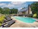 Backyard with a swimming pool, a deck, outdoor seating and lounge chairs at 3573 Northern Estates Cir, Rocky Mount, NC 27804