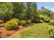 Well-manicured backyard with lush greenery, providing a serene and private outdoor space at 3806 Stoneybrook Dr, Durham, NC 27705