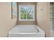 Bright bathroom with a soaking tub and a window offering natural light at 3806 Stoneybrook Dr, Durham, NC 27705