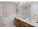 Bathroom with double vanity, tiled floor, large mirror, and modern fixtures at 3806 Stoneybrook Dr, Durham, NC 27705