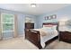A bright bedroom featuring a large window, a dresser and a bed at 3806 Stoneybrook Dr, Durham, NC 27705