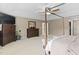 Large bedroom with four-poster bed, neutral colors, a ceiling fan, and a carpeted floor at 3806 Stoneybrook Dr, Durham, NC 27705