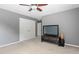 A standard bedroom with an entertainment center, closet and windows at 3806 Stoneybrook Dr, Durham, NC 27705