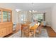 Bright dining area with wood table, china cabinet and seating area by the entry at 3806 Stoneybrook Dr, Durham, NC 27705
