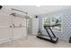 Exercise room with treadmill, weight rack, and geometric patterned wallpaper at 3806 Stoneybrook Dr, Durham, NC 27705