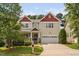 Inviting two-story home featuring a charming front porch and a convenient two-car garage at 3806 Stoneybrook Dr, Durham, NC 27705