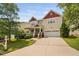 Inviting two-story home featuring a charming front porch and a convenient two-car garage at 3806 Stoneybrook Dr, Durham, NC 27705