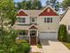 Inviting two-story home featuring a charming front porch and a convenient two-car garage at 3806 Stoneybrook Dr, Durham, NC 27705