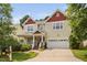 Inviting two-story home featuring a charming front porch and a convenient two-car garage at 3806 Stoneybrook Dr, Durham, NC 27705