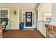 Inviting front porch with rocking chair, blue planter, and decorative wreath on the front door at 3806 Stoneybrook Dr, Durham, NC 27705