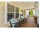 Relaxing front porch features rocking chairs, stylish cushions, and an inviting entryway at 3806 Stoneybrook Dr, Durham, NC 27705