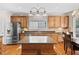 Well-equipped kitchen featuring stainless appliances, wood cabinets, and center island with bar stools at 3806 Stoneybrook Dr, Durham, NC 27705