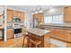 Modern kitchen with stainless appliances, central island with granite countertops and breakfast bar seating at 3806 Stoneybrook Dr, Durham, NC 27705