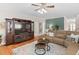 Spacious living room featuring a large entertainment center, a fireplace and comfortable seating at 3806 Stoneybrook Dr, Durham, NC 27705