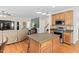 The living room is connected to the kitchen, and features stainless steel appliances and granite countertops at 3806 Stoneybrook Dr, Durham, NC 27705