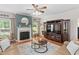 Bright living room with fireplace, a ceiling fan and a large entertainment center, with an area rug at 3806 Stoneybrook Dr, Durham, NC 27705
