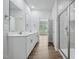 Bathroom featuring double sinks and a tiled standing shower with glass door at 3813 Rosebush Dr, Zebulon, NC 27597