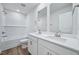 Modern bathroom with double vanity, sleek fixtures, and tile surround at 3813 Rosebush Dr, Zebulon, NC 27597