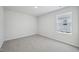 Cozy bedroom features neutral walls and soft carpeting under natural light at 3813 Rosebush Dr, Zebulon, NC 27597
