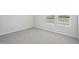 Sunlit bedroom boasts cozy carpet and bright white trim around double windows at 3813 Rosebush Dr, Zebulon, NC 27597