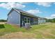 Exterior showcasing blue siding, green lawn, and covered patio at 3813 Rosebush Dr, Zebulon, NC 27597