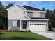 Charming two-story home featuring a two-car garage, well-manicured lawn, and welcoming front porch at 3813 Rosebush Dr, Zebulon, NC 27597