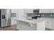 Kitchen island with stainless appliances, quartz countertop, and gray tile backsplash at 3813 Rosebush Dr, Zebulon, NC 27597