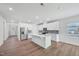 Modern kitchen with white cabinets, stainless appliances, center island and wood-look floors at 3813 Rosebush Dr, Zebulon, NC 27597