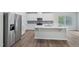 Spacious kitchen featuring white cabinetry, stainless steel appliances, and a center island at 3813 Rosebush Dr, Zebulon, NC 27597