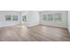 Open-concept living area with wood floors, bright lighting and backyard views at 3813 Rosebush Dr, Zebulon, NC 27597