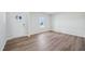 Bright, open floor plan with wood-look flooring, neutral walls, and a front door view at 3813 Rosebush Dr, Zebulon, NC 27597