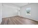 Empty living room featuring wood-look flooring and ample natural light from the window at 3813 Rosebush Dr, Zebulon, NC 27597