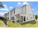 Townhome exterior with a covered patio and green lawn at 479 Clark Creek Ln, Cary, NC 27519