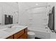 Bright bathroom featuring a shower-tub combo, modern fixtures, and a white single sink vanity at 479 Clark Creek Ln, Cary, NC 27519