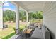 Relaxing covered patio features outdoor seating and a serene view of the landscaped yard at 479 Clark Creek Ln, Cary, NC 27519