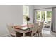 Bright dining area with a stylish table and chairs, and a sliding glass door at 479 Clark Creek Ln, Cary, NC 27519