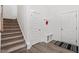 Inviting foyer with carpeted stairs, coat rack, and white trim at 479 Clark Creek Ln, Cary, NC 27519