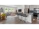 Open concept living space features a kitchen, dining space, and living area with lots of light at 479 Clark Creek Ln, Cary, NC 27519