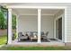 Cozy covered patio with modern outdoor furniture and neutral decor at 479 Clark Creek Ln, Cary, NC 27519