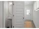 Stylish powder room featuring a pedestal sink, modern lighting, and tile flooring at 479 Clark Creek Ln, Cary, NC 27519