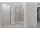 Tiled walk-in shower with glass door and neutral flooring at 479 Clark Creek Ln, Cary, NC 27519