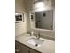 Bathroom featuring quartz countertops, white cabinetry, and brushed metal faucet at 500 Umstead Dr # D307, Chapel Hill, NC 27516