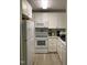 Compact kitchen with white cabinets, stainless steel appliances and modern countertops at 500 Umstead Dr # D307, Chapel Hill, NC 27516