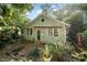 Charming backyard view featuring patio, lush plantings, and the exterior of a well-maintained home at 513 Cutler St, Raleigh, NC 27603
